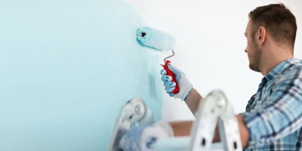 3 man paiting room light blue - DIY vs. Tradesman Hire: A few easy home repairs every man should master