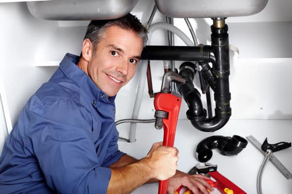4 man with wrench plumbing - DIY vs. Tradesman Hire: A few easy home repairs every man should master