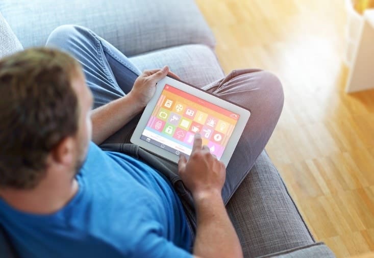men using mobile tablet - Have a Smart Home Set up? Here’s How to Keep It Safe From Hackers