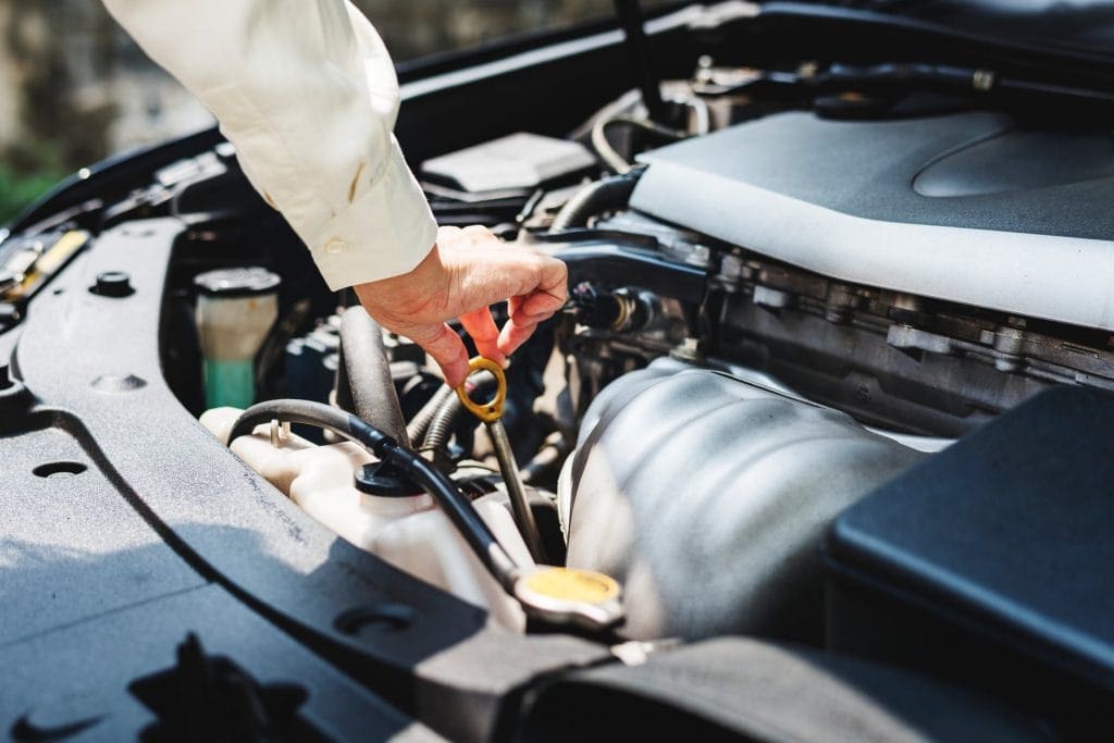 oil check 1024x683 - 7 Essential  Car Maintenance Tips
