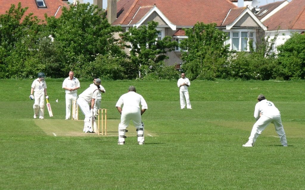 Team playing Cricket in the field 